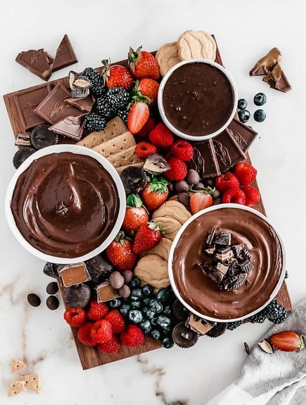 Image shows a sweet dessert board with cookies, fruits, chocolates, and more. via lively table