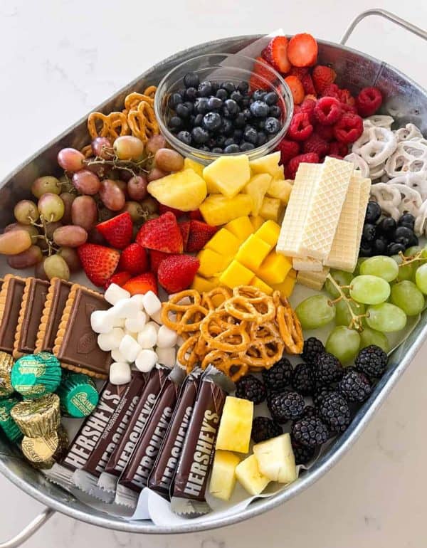 Image shows a dessert tray with chocolate and fresh fruits. via picky palate