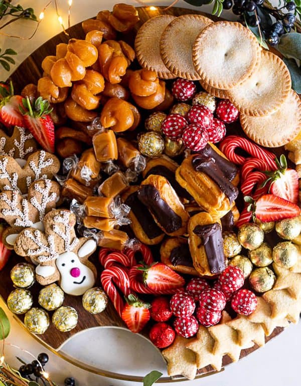 Image shows a sweet and savory charcuterie board with a christmas theme. idea from simply delicious