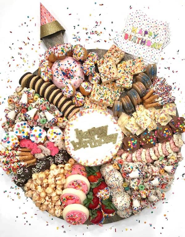 Image shows a dessert board with a birthday theme. via the baker mama