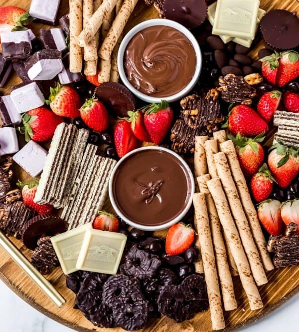 Image shows a chocolate dessert board with fruits and dips. from wanderlust & wellness.