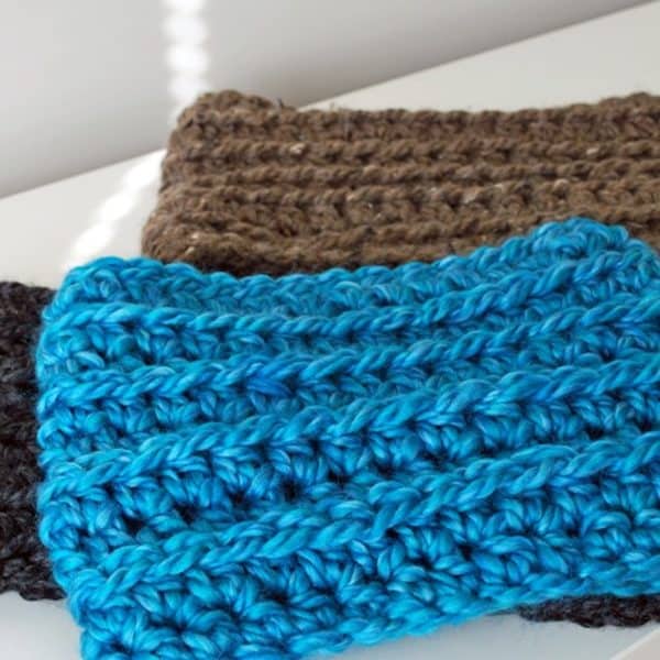 blue and brown kids crochet cowl on white table skip to my lou