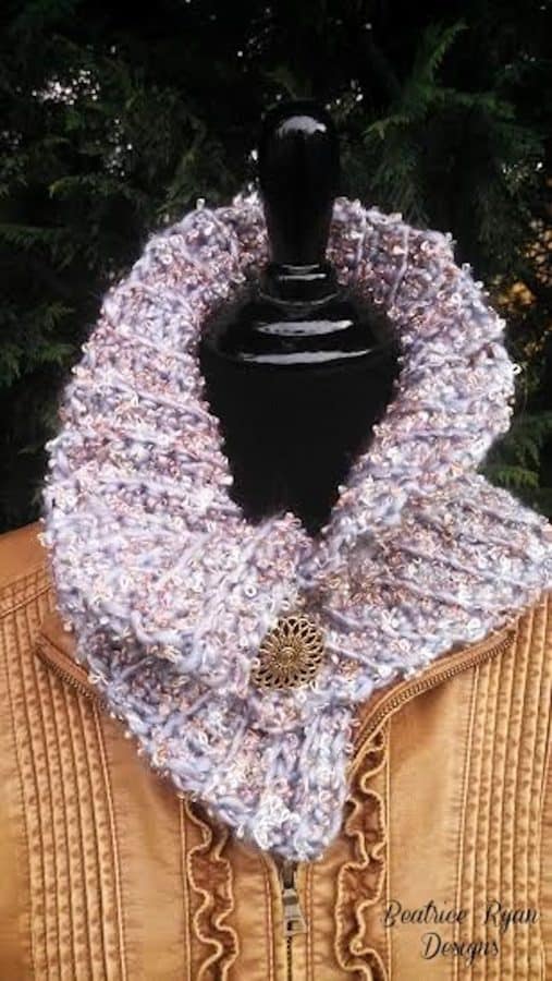 purple multicolored crochet cowl on model with brown coat