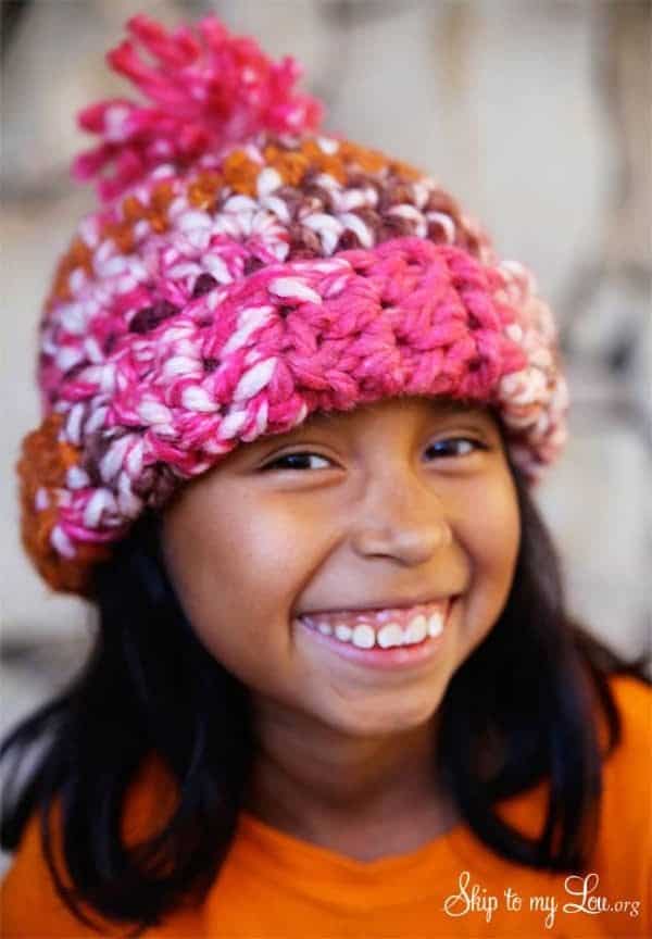 pink multicolor crochet hat on a smiling girl