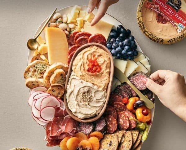 Image shows a charcuterie hummus board.