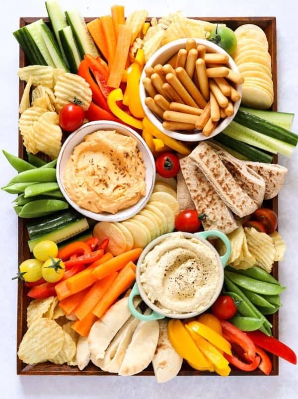 Image shows a no cook hummus and vegetable board.