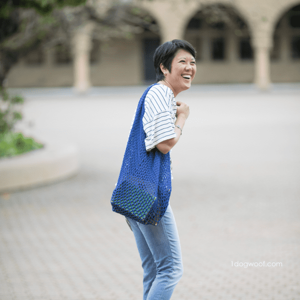Blue crochet mesh bag on woman in the street skip to my lou