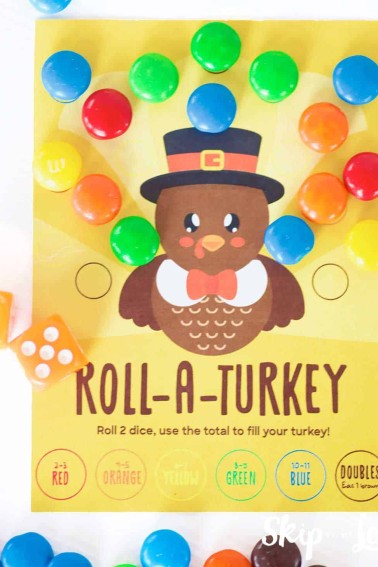 roll a turkey game card from skip to my lou with dice and m&m's