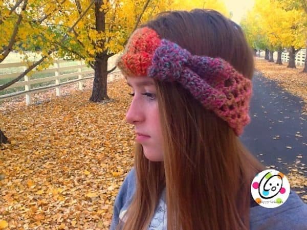 crochet headband on girl outside by fall leaves skip to my lou