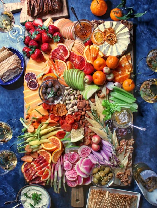 whipped cheese board recipes-the delicious life- a large board with almost anything you could image from a variety of veggies and fruit to honeycomb, olives, and more.