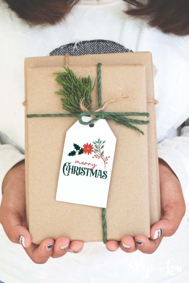 Merry Christmas gift tag on a craft paper wrapped gift with green twine