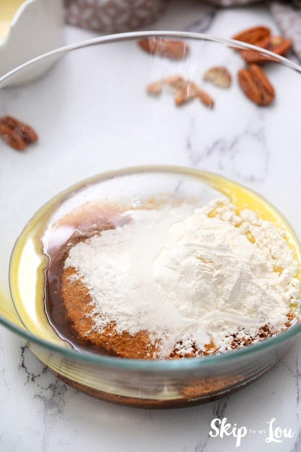 Image shows the process of making a praline sauce with the ingredients in a bowl. - Skip To My Lou