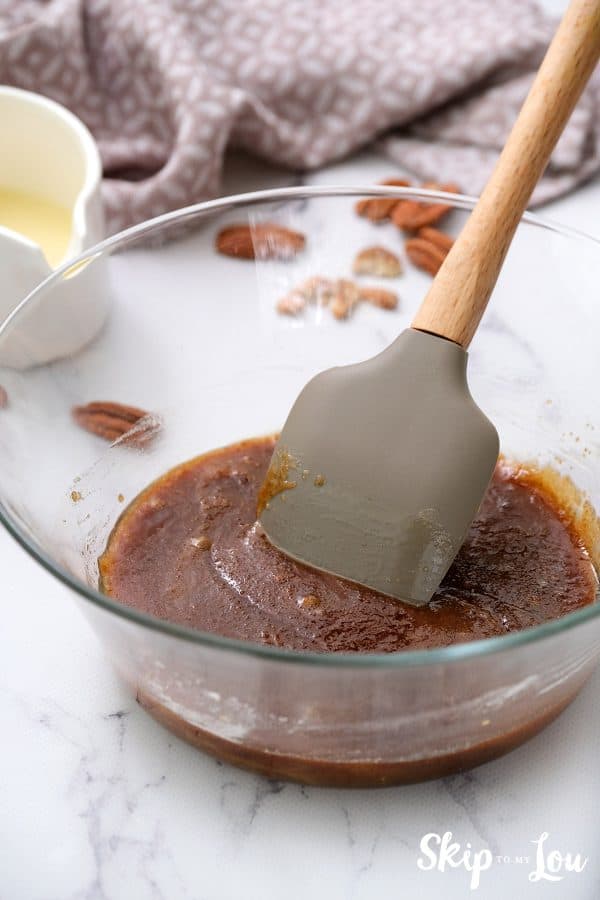 Image shows the process of mixing a praline sauce. - Skip to my lou
