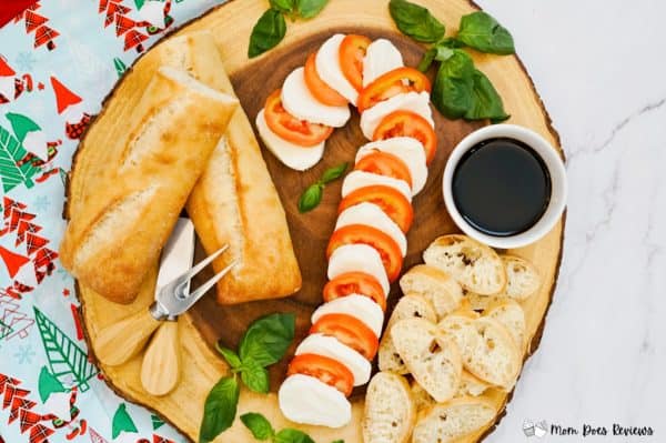 candy cane charcuterie board ideas- a heartier board with tomatoes mozzarella, and bread. 