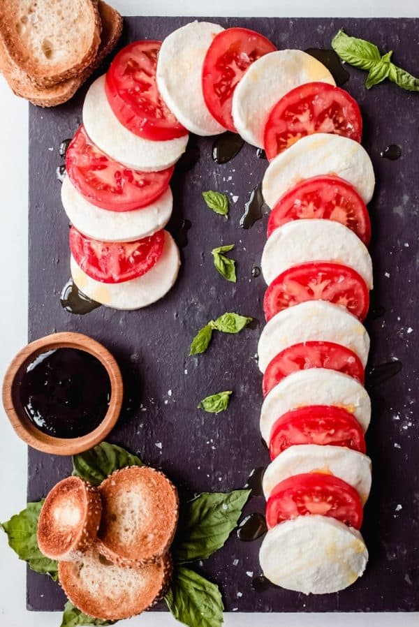 candy cane charcuterie board ideas- a 5-ingredient board of mozzarella cheese, and tomatoes that can be made and served within 10 minutes. 