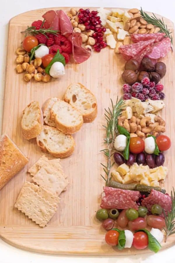 candy cane charcuterie board ideas- a board with meats, cheeses, and fresh fruit. 