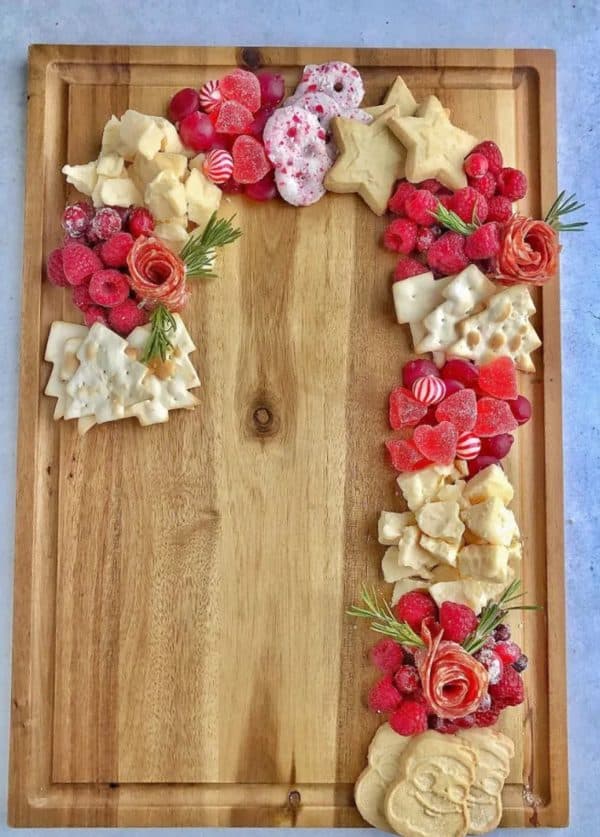 candy cane charcuterie board ideas- a board cookies, candies, fruit, and more,