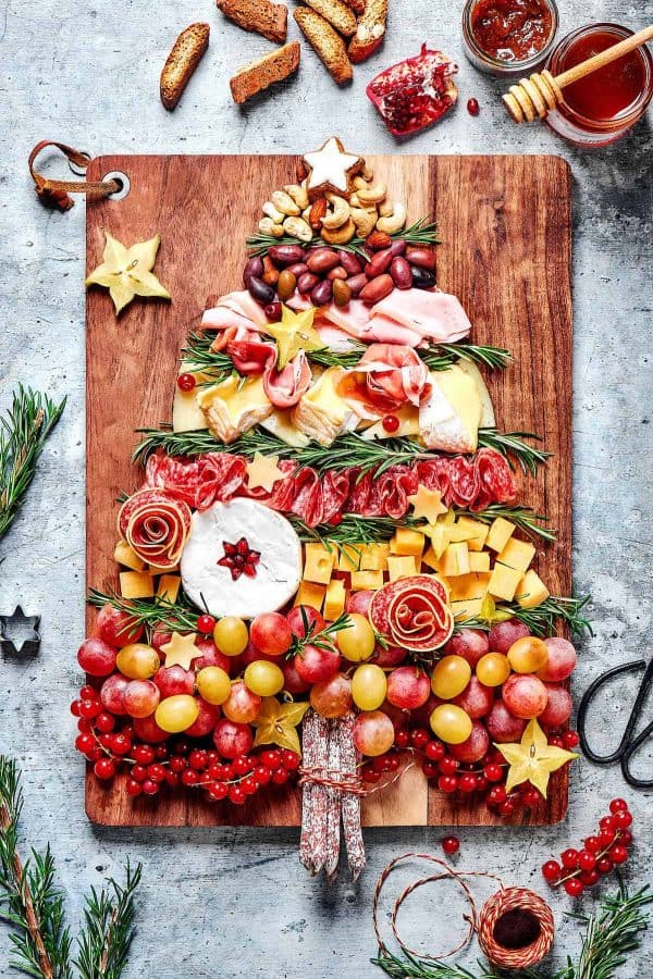 christmas tree charcuterie board ideas- a large board with all the ingridents needed for a charcuterie board