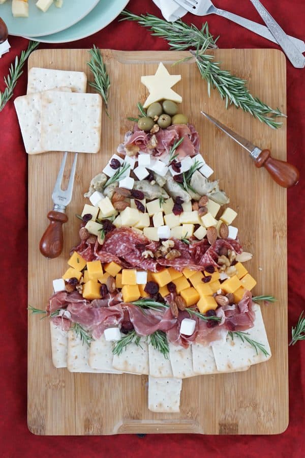 christmas charcuterie board- a simple board with crackers for the base of the tree