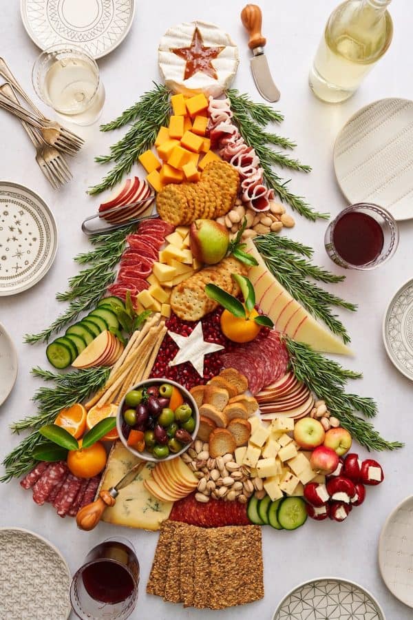 christmas tree charcuterie board ideas-a wild christmas tree with may cheeses and meat. 