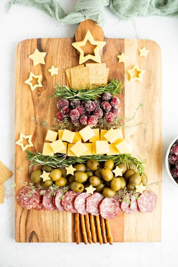 christmas tree charcuterie board ideas- a simple tree with pretzel trunk, sugar covered cranberries, and more. 