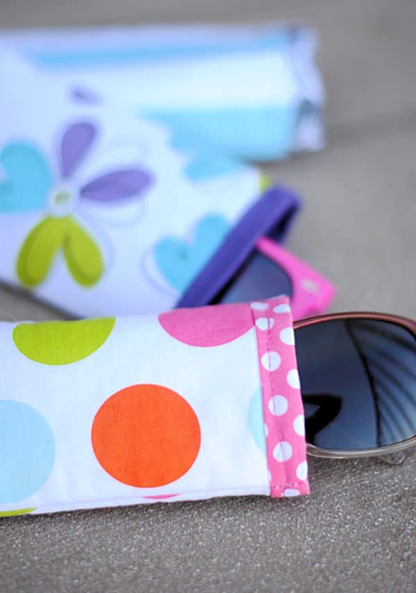 Sunglasses cases with different patterns and sunglasses out of them.
