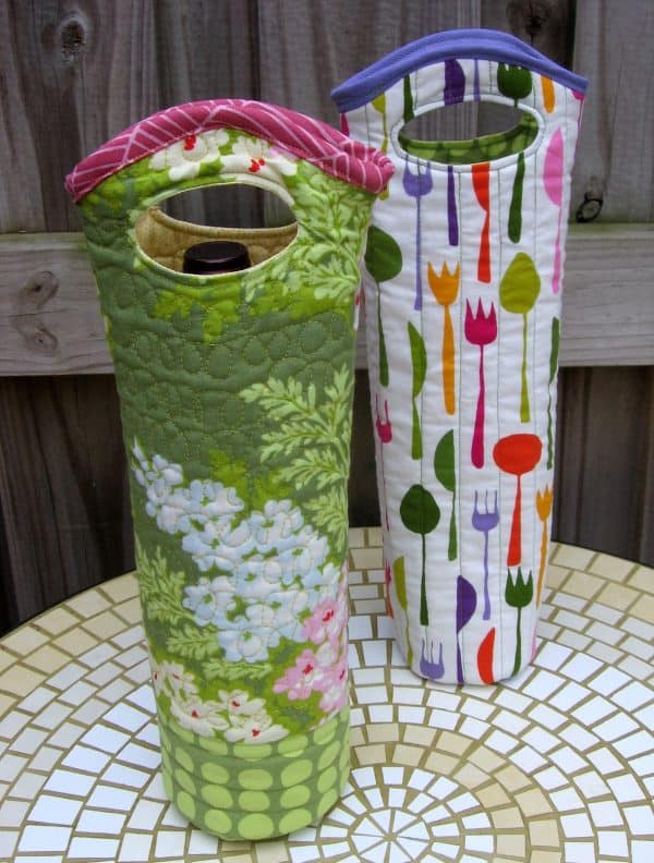 Two quilted wine totes in different designs.