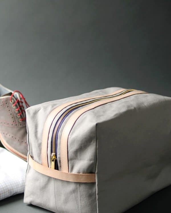 Travel bag with shoes behind it.
