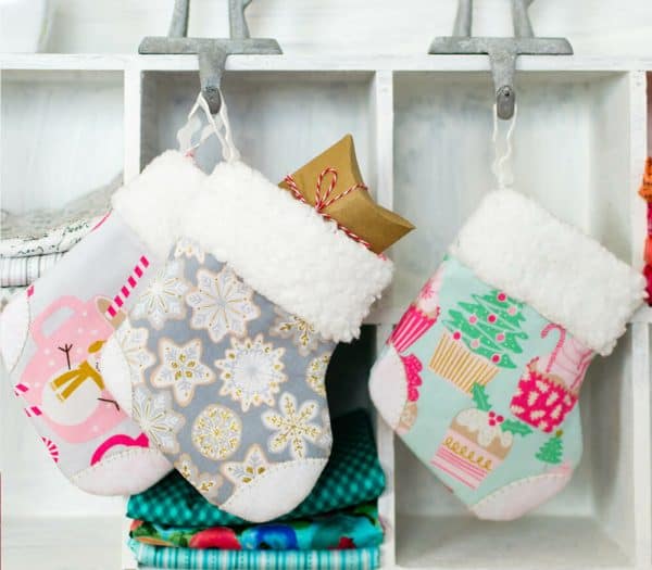 Image shows three stockings hanging from a wall.