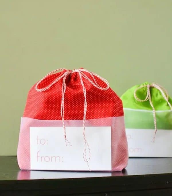 Image shows two gift bags in red and green with gift tags.