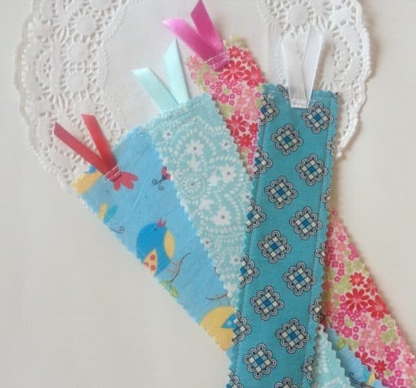 Fabric scrap bookmarks with different designs and colors next to each other.