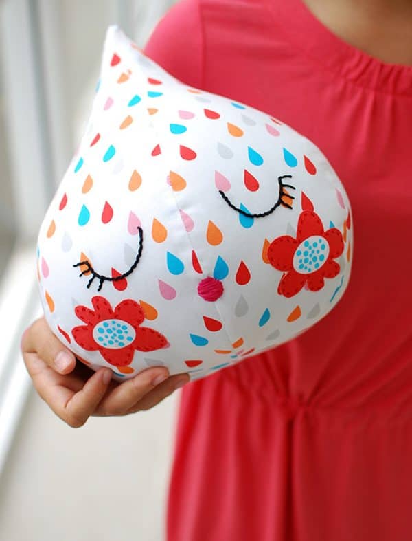 Cute raindrop softie beign held by a child.