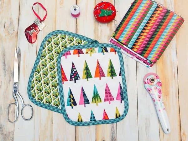 Image shows two pot holders with the materials and supplies next to it.