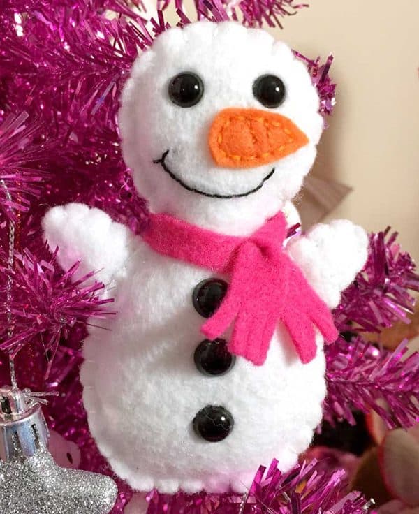 Image shows a mini snowman softie on a pink christmas tree.