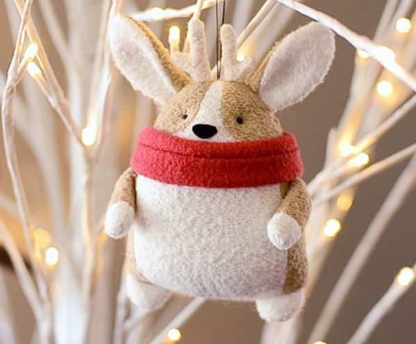 Image shows a DIY sewn plushie hanging from a tree.