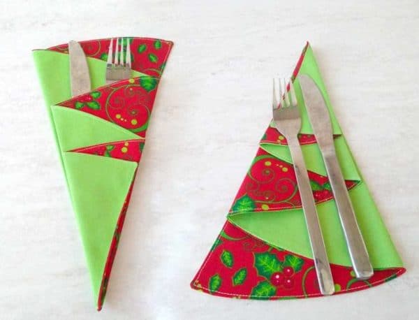 Image shows Christmas tree napkins with festive patterns. 