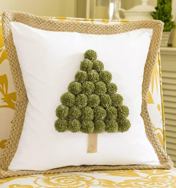 Image shows a Christmas tree pom pom pillow.