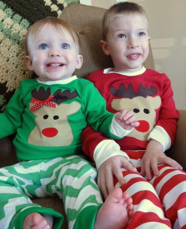 Image shows two little boys wearing reindeer pajamas.
