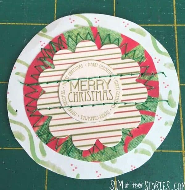 Image shows a stitched paper christmas card that says "Merry Christmas"