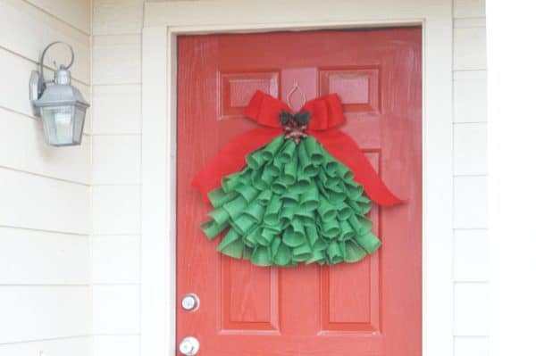 Image shows a dIY burlap christmas tree hanging from a wall.
