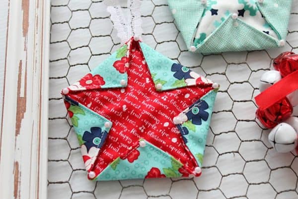 Image shows a fabric star hanger with decorations.
