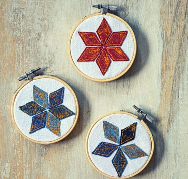 Image shows three embroidery hoop ornaments.