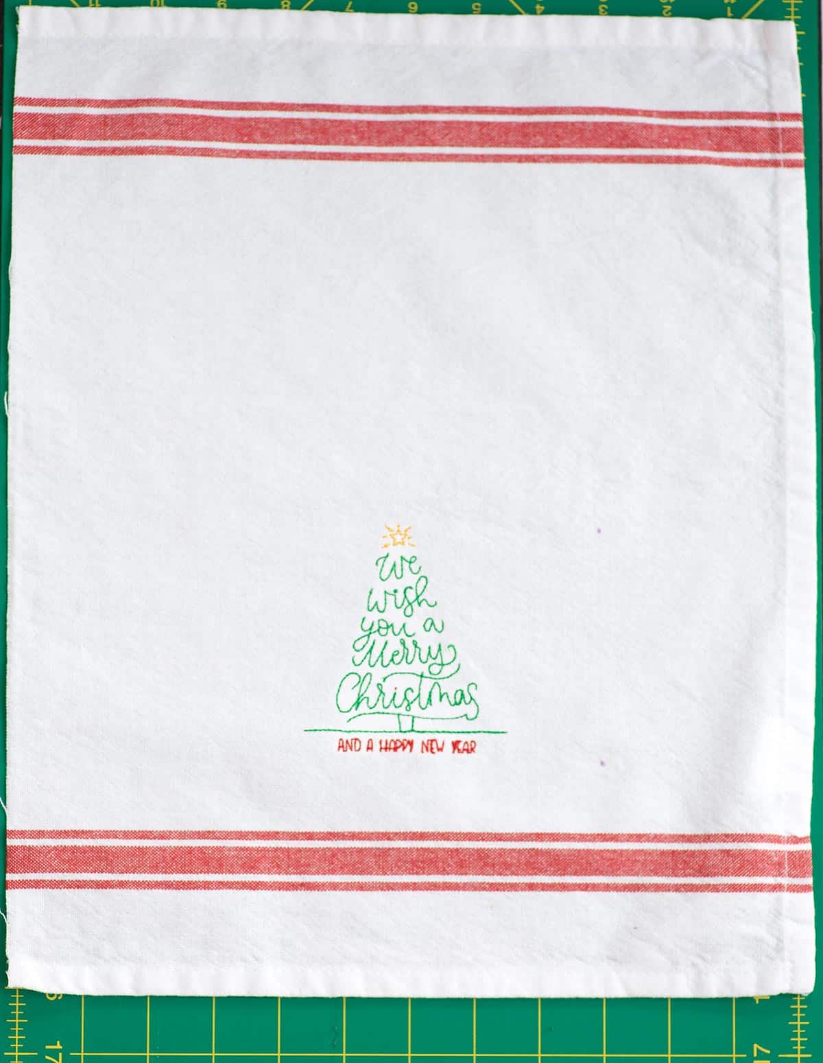 we wish you a merry christmas machine embroidered on half the towel