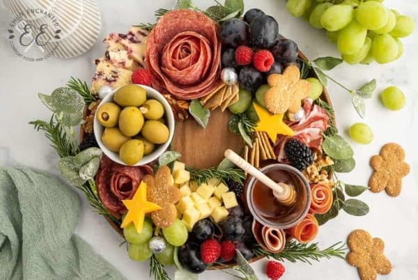wreath charcuterie board ideas with honey, olives, and salami