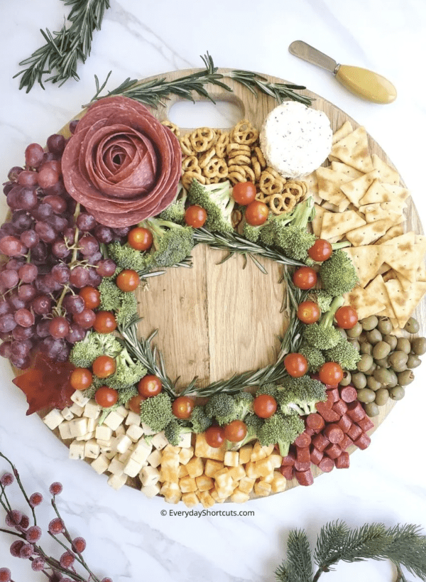 wreath charcuterie board ideas- a large array of foods with vegetables, meat, cheese, and crackers