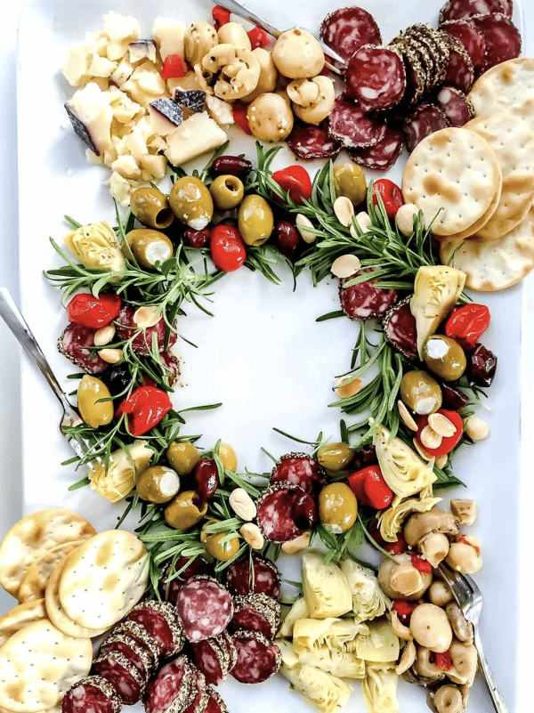 wreath charcuterie board ideas- olives, crackers, tomatoes, and more.