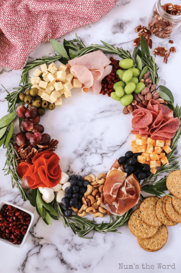 wreath charcuterie board ideas with salami, pepperoni, ham, cheese, and more. 