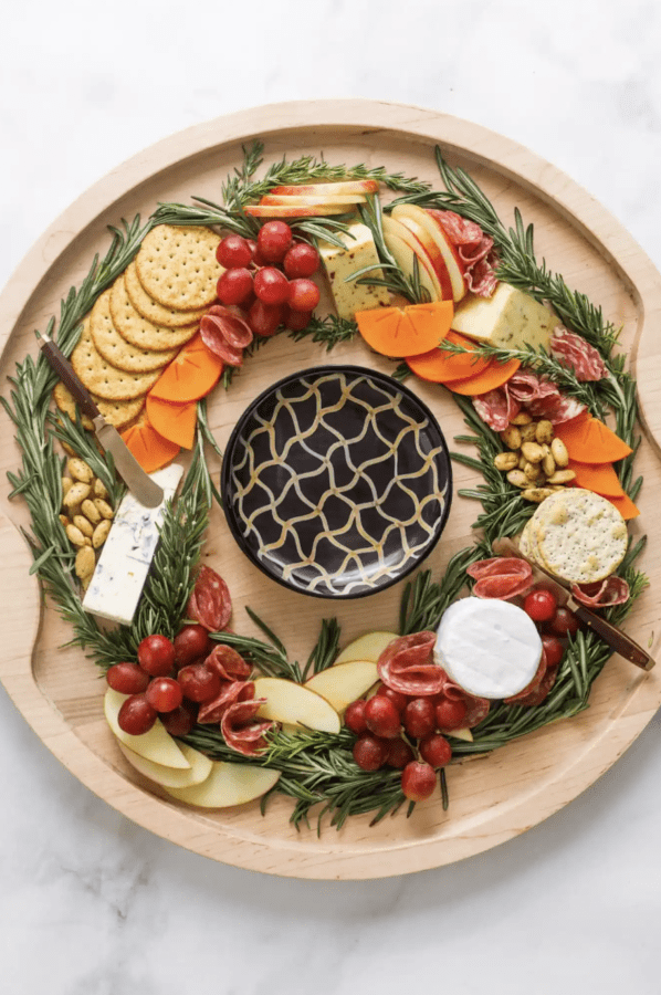 wreath charcuterie board ideas with simple cheeses, crackers, fruit, and meats. 