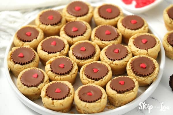 20 Reece's Peanut Butter Cup cookies on a round, white plate, by Skip to my Lou.
