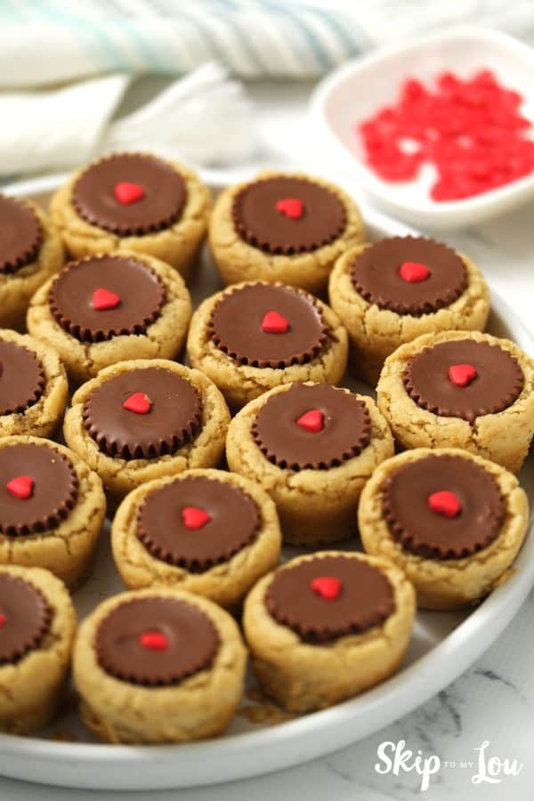 14 Reece's Peanut Butter Cup cookies on a round white plate, by Skip to my Lou.